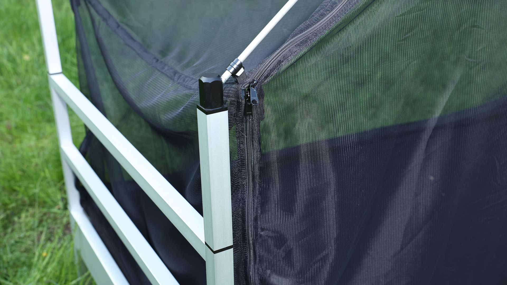 Close-up of a bedpost of the SkyHeia outdoor bed, in which a telescopic pole is inserted that holds the mosquito net.